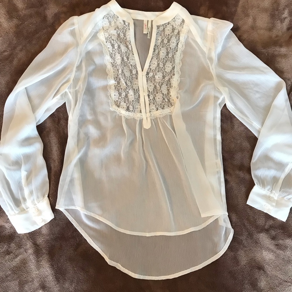 Sheer white blouse with lace.